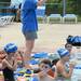 Buhr Park Shark swim mom Theresa Woodside sounds a bell as a swimmer reaches a new goal while swimming laps to raise funds for Ann Arbor Active Against ALS and Bob Schoeni at the Buhr Park Pool on Wednesday morning. Melanie Maxwell | AnnArbor.com